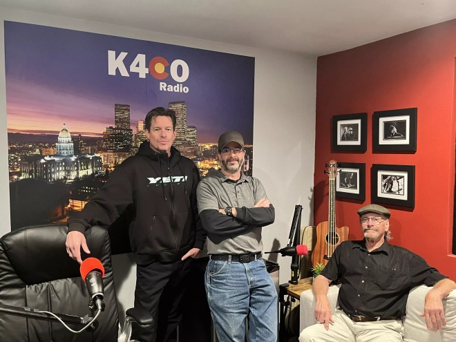 three men standing in a radio room