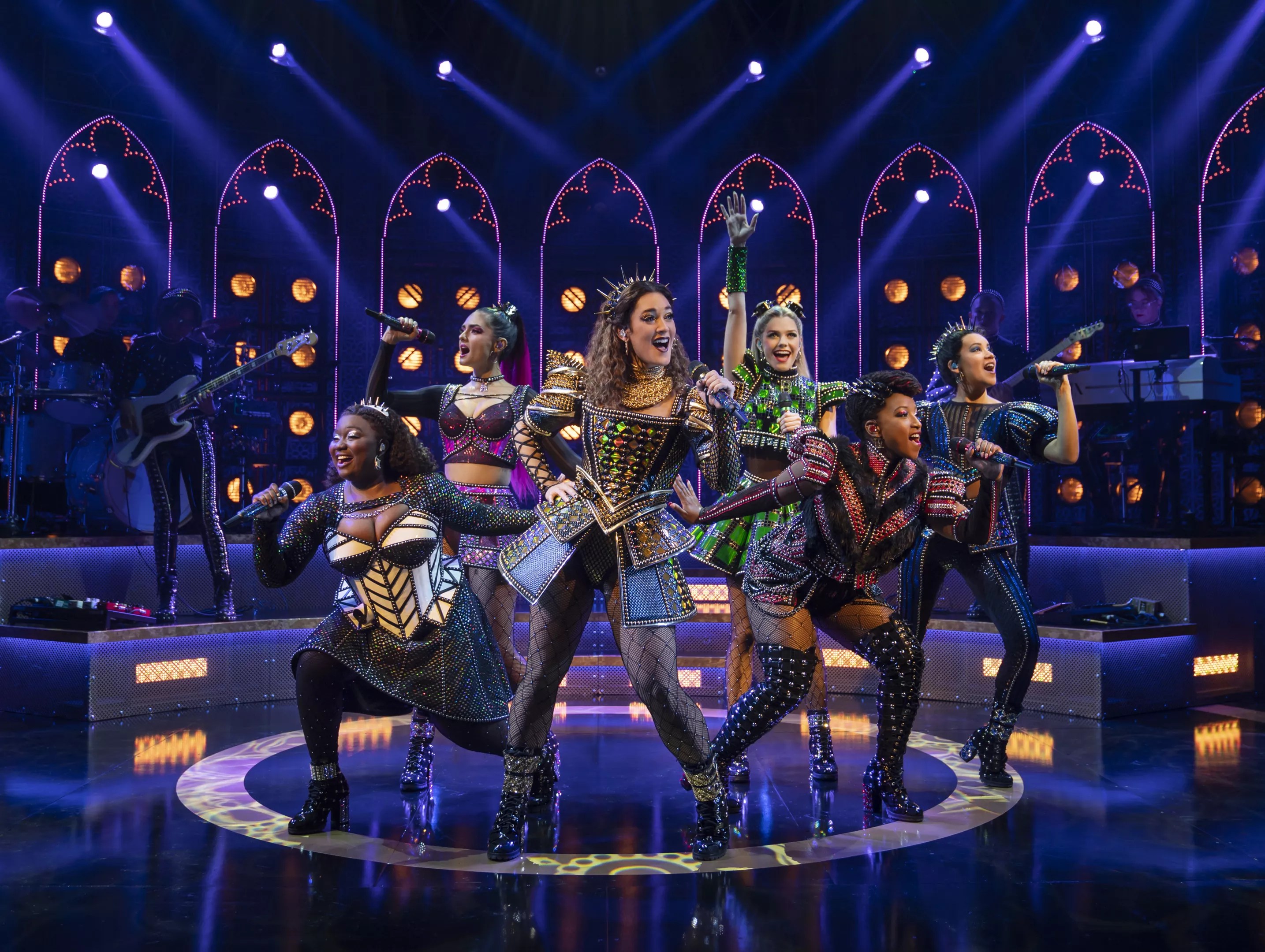 six women on stage in medieval costumes