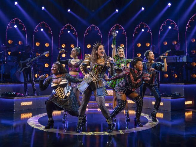 six women on stage in medieval costumes