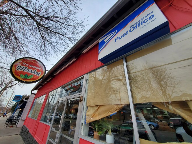 a post office sign on the front of a building