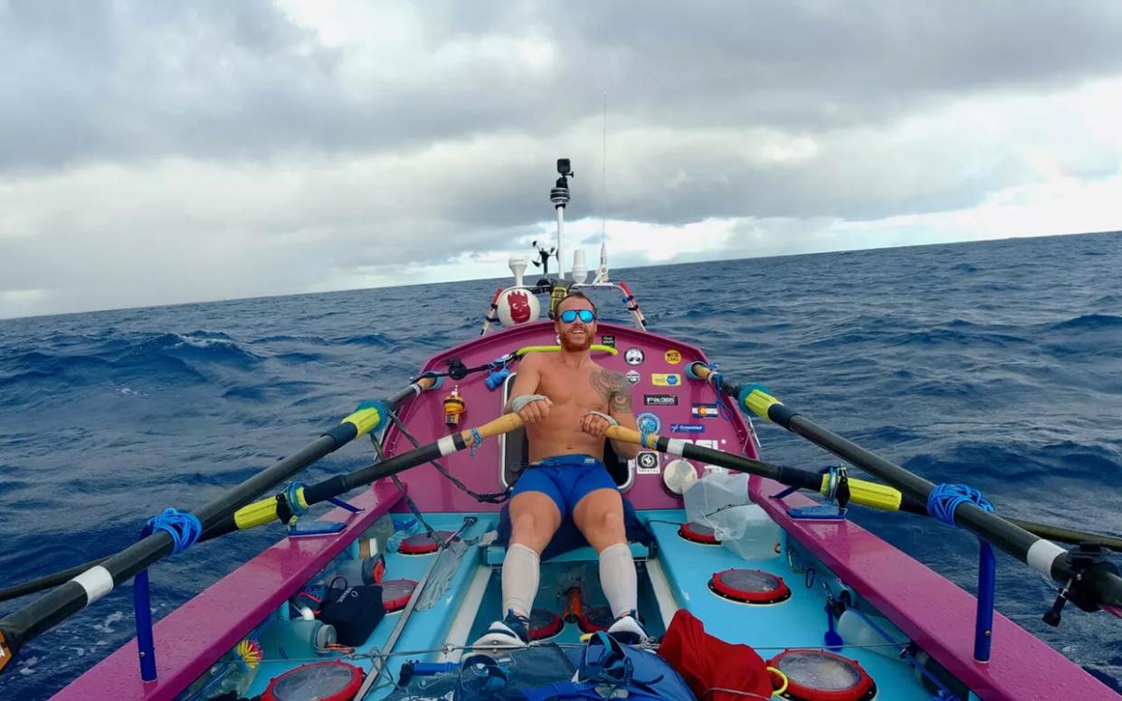 man in boat rowing on ocean