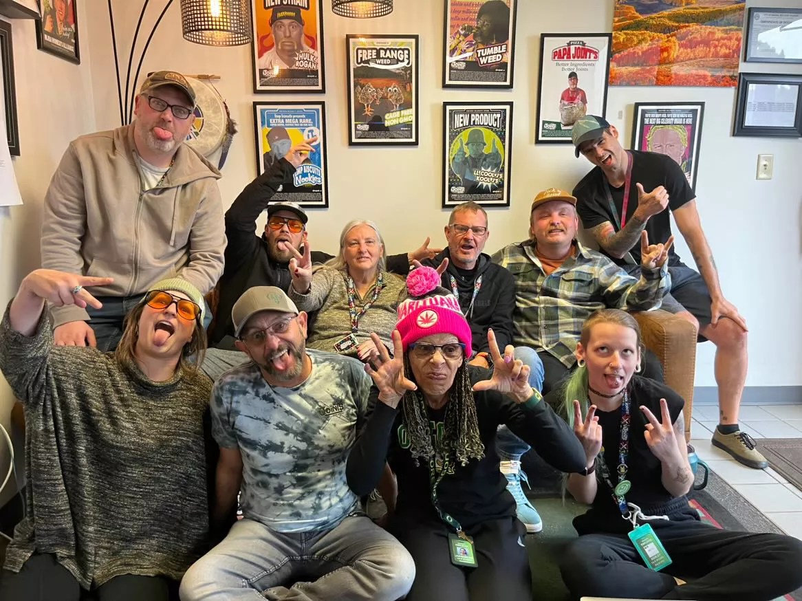 Group of people sit on a couch and laugh