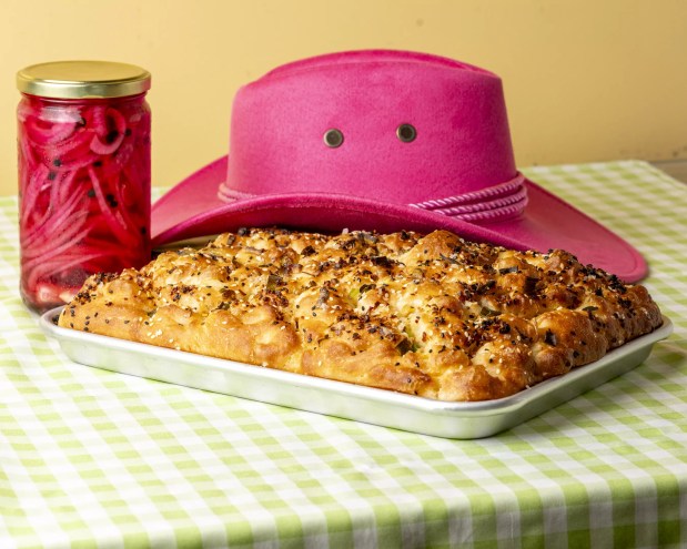 foccacia on a pan in front of a pink cowboy hat