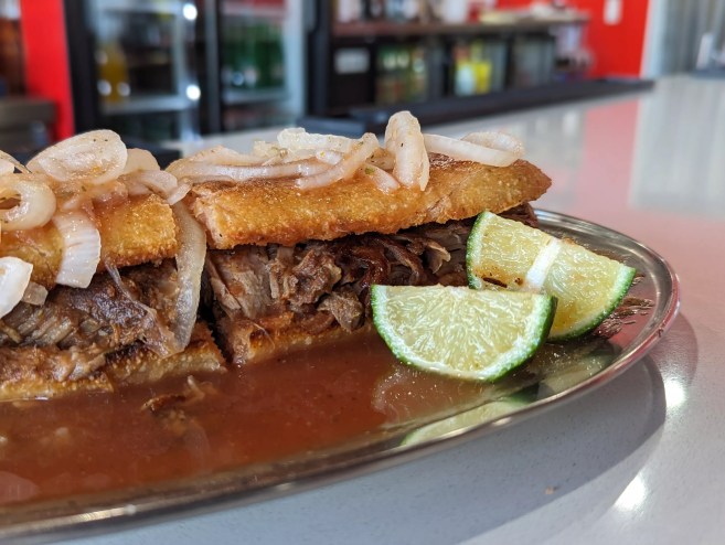 a torta sandwich on a silver plate