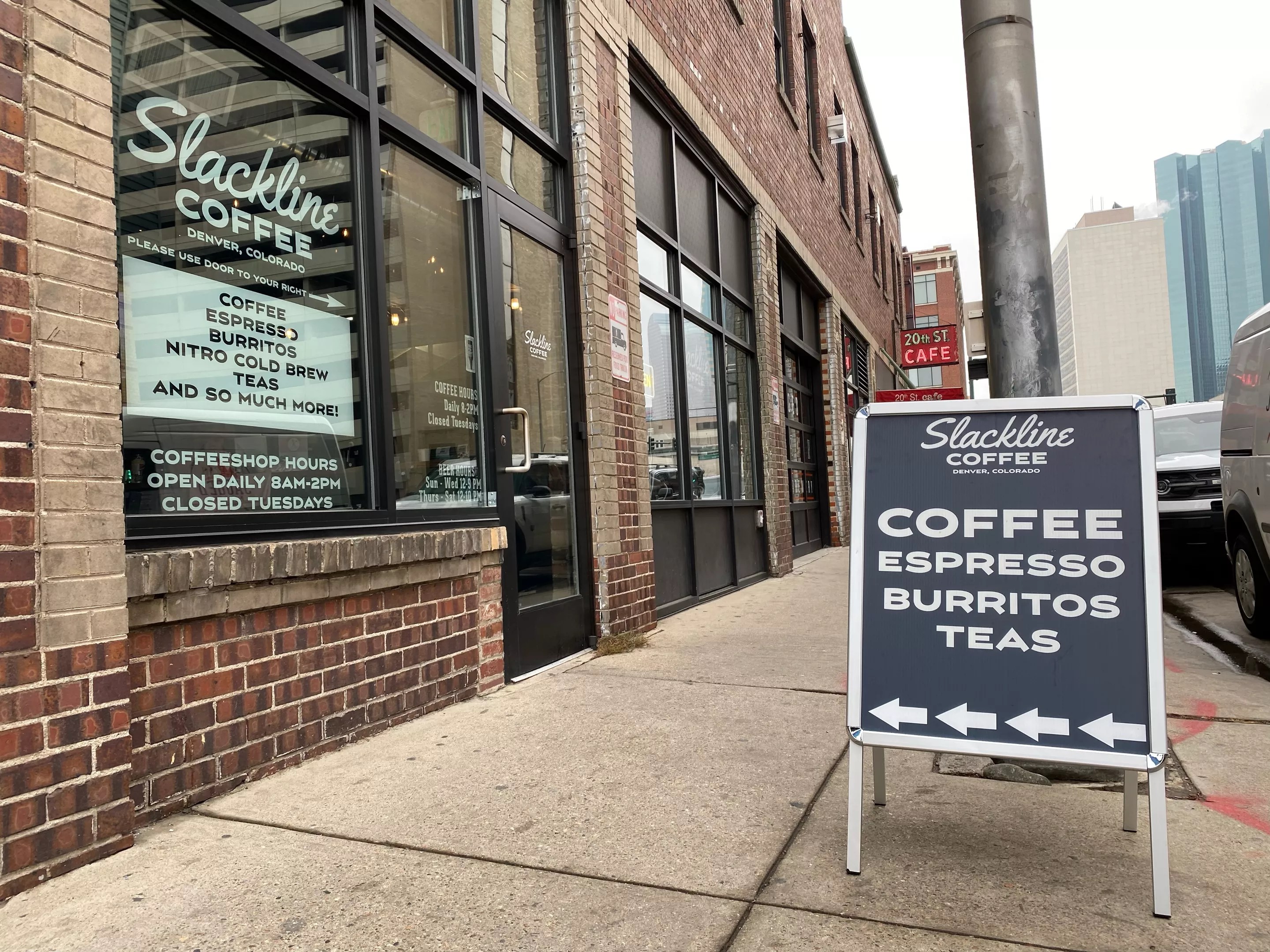 sandwich board sign in front of a brick building