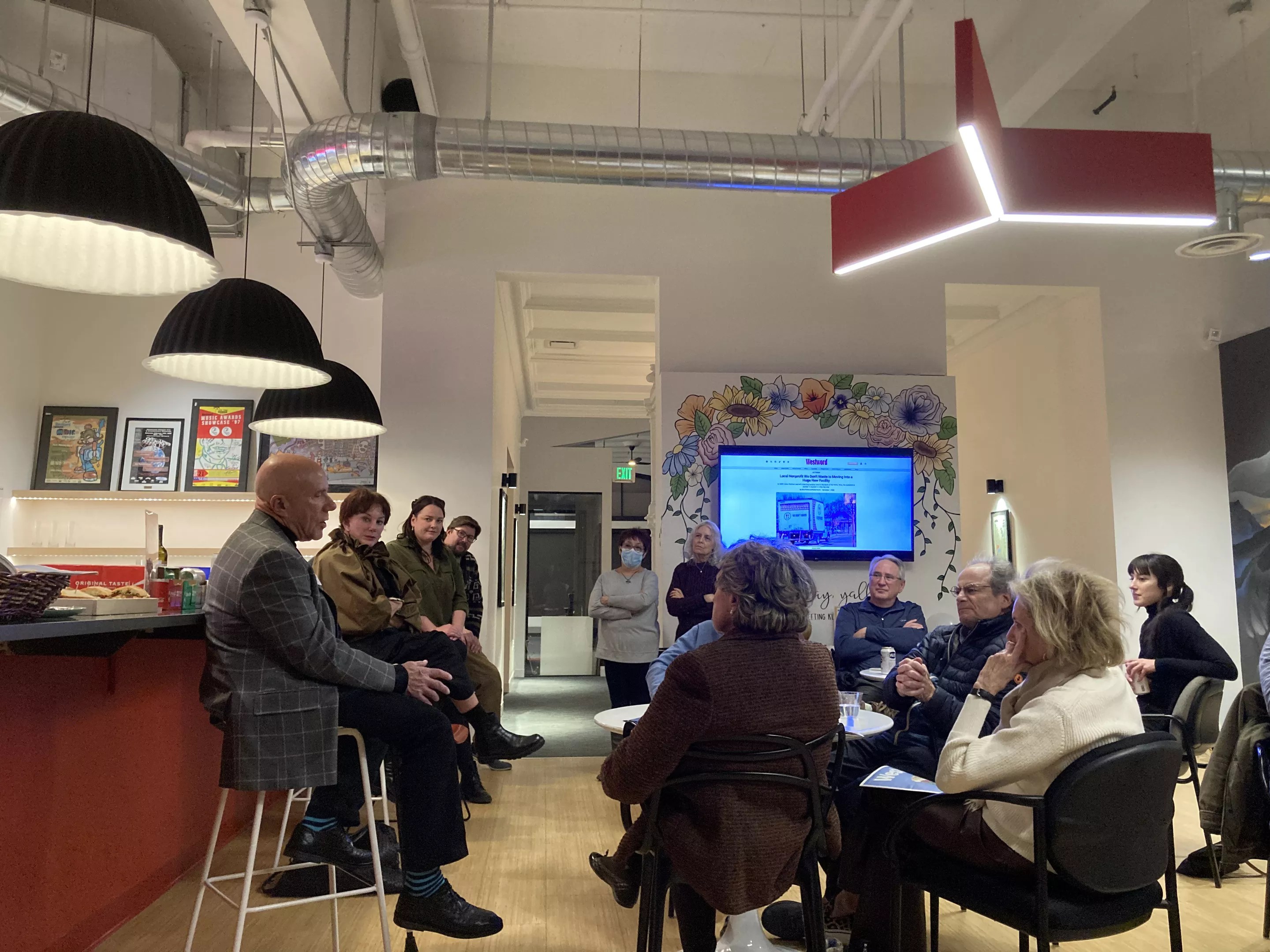 man talking to gathering in office