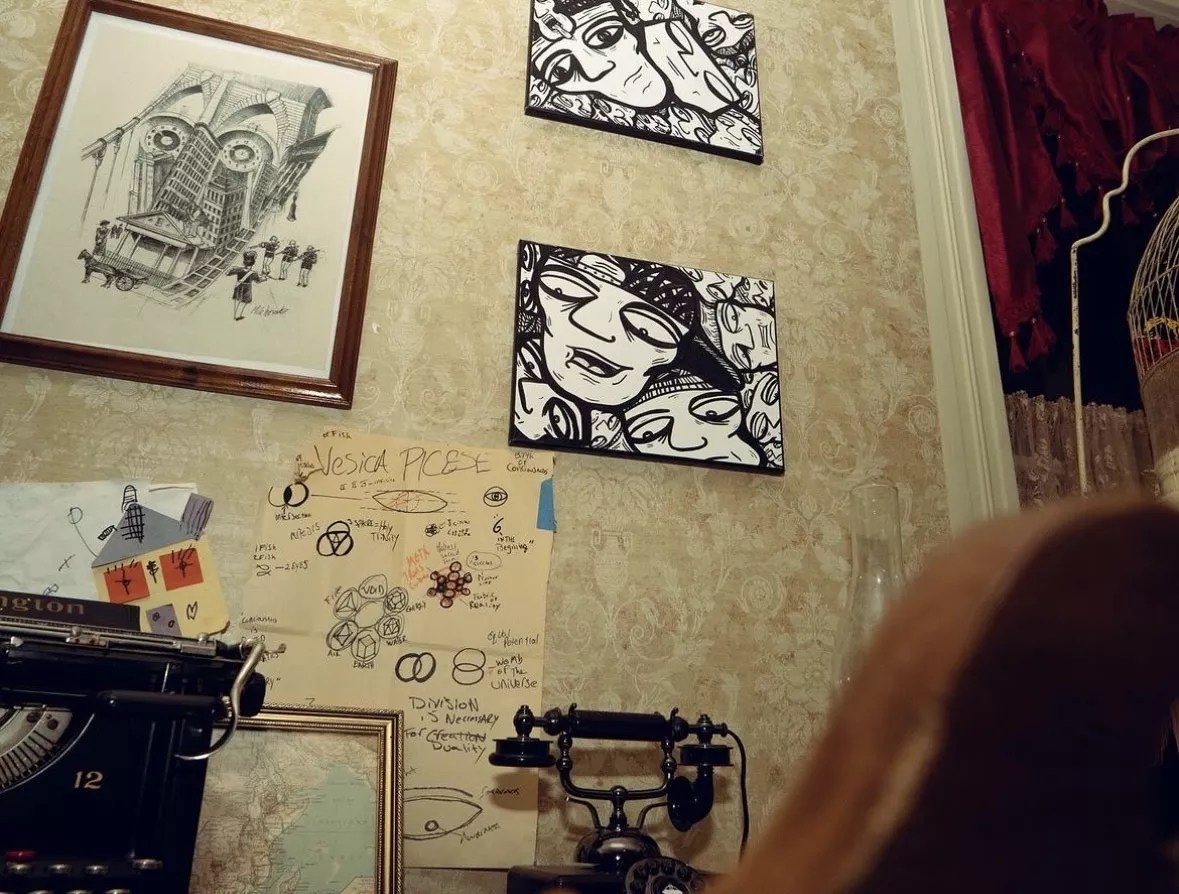 Black and white paintings on the wall of an old mansion