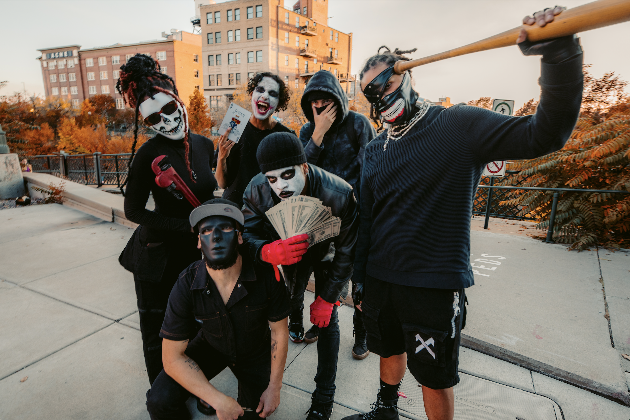 rappers dressed as clowns pose in a parking lot