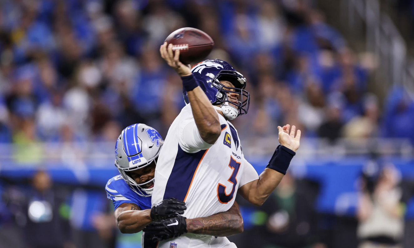 Denver Broncos quarterback Russell Wilson throwing a football.