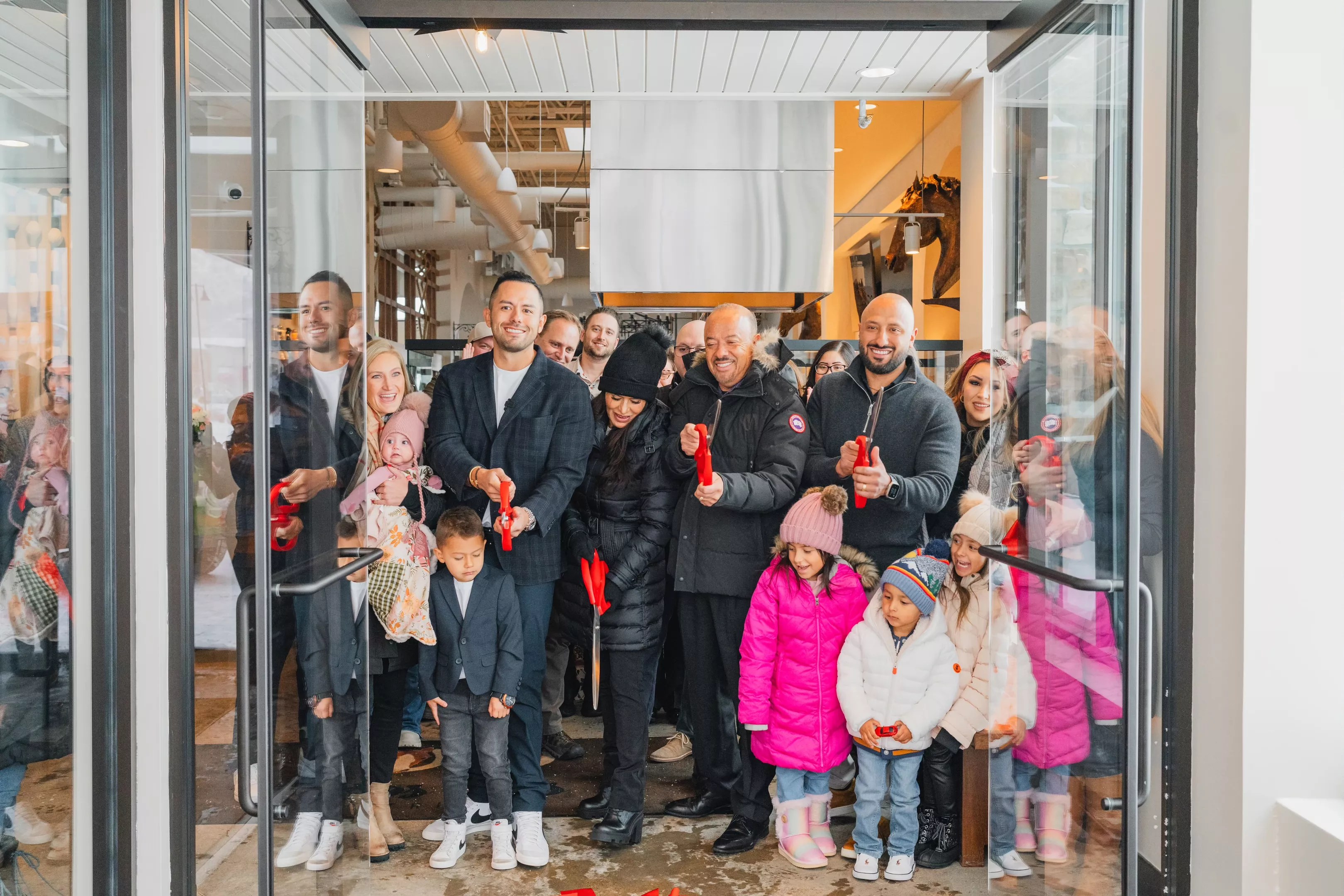 a group of people at a ribbon cutting
