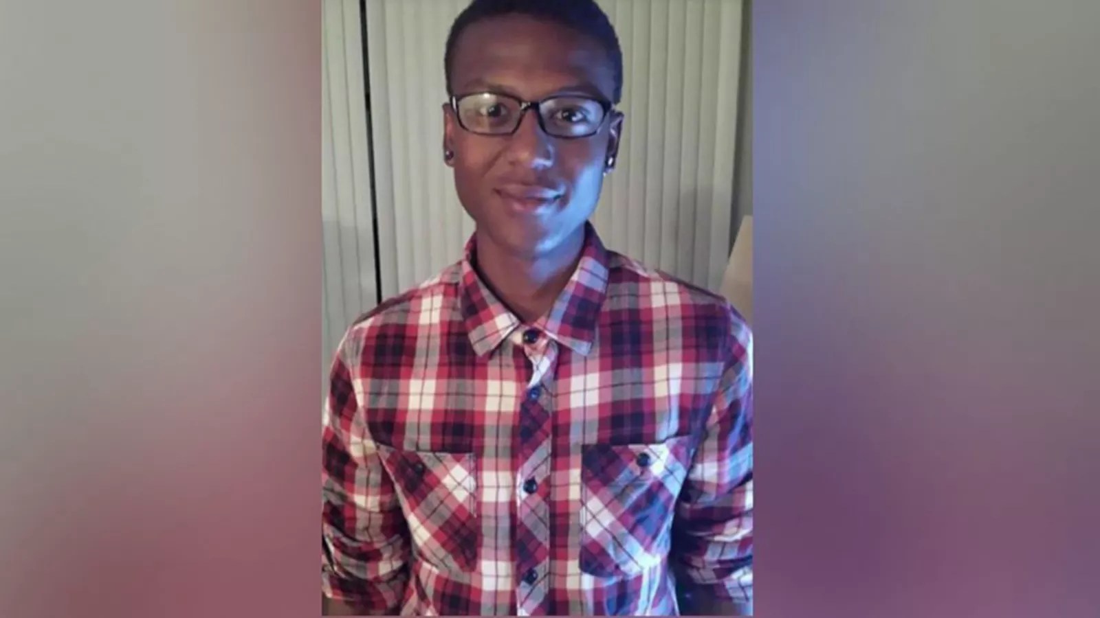 young black man in checked shirt with glasses