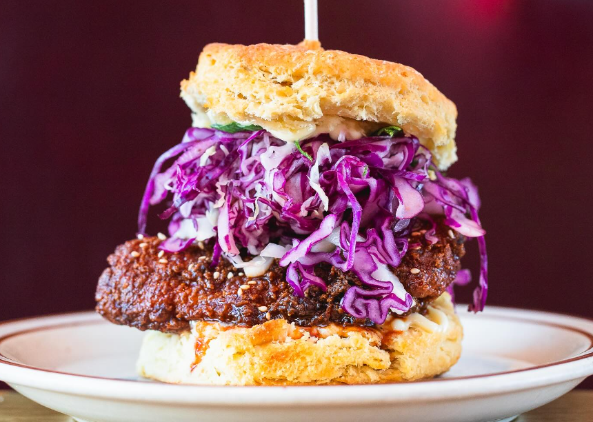 a biscuit sandwich with fried chicken and cabbage