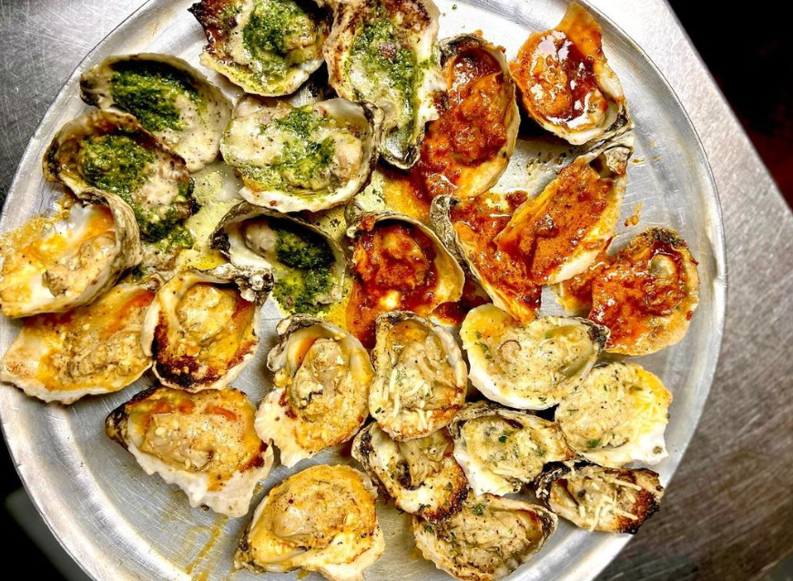 a platter of grilled oysters