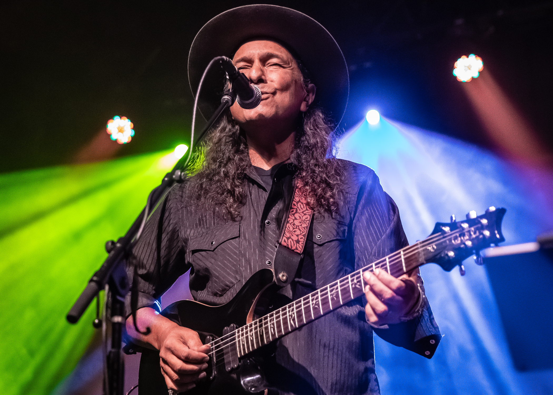 man singing and playing guitar