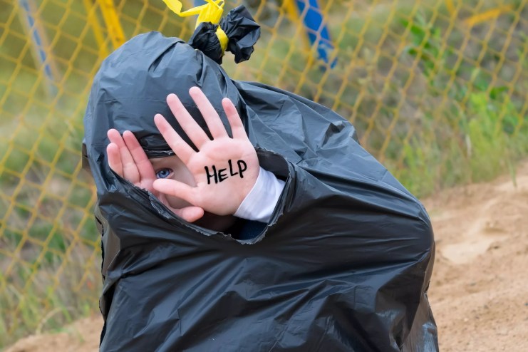 child in trash bag