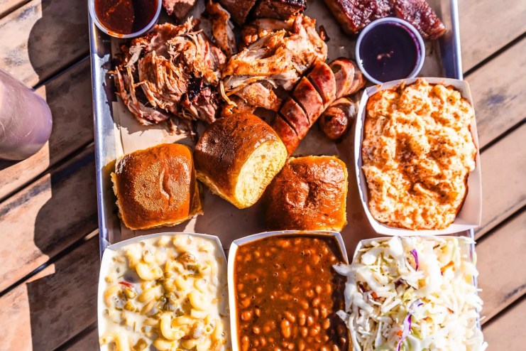 a platter of barbecue meats and sides