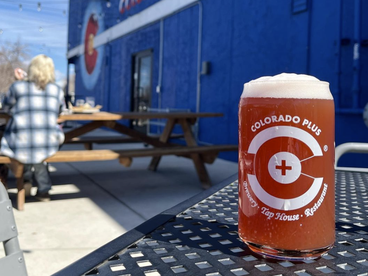 a glass of beer on a table outside