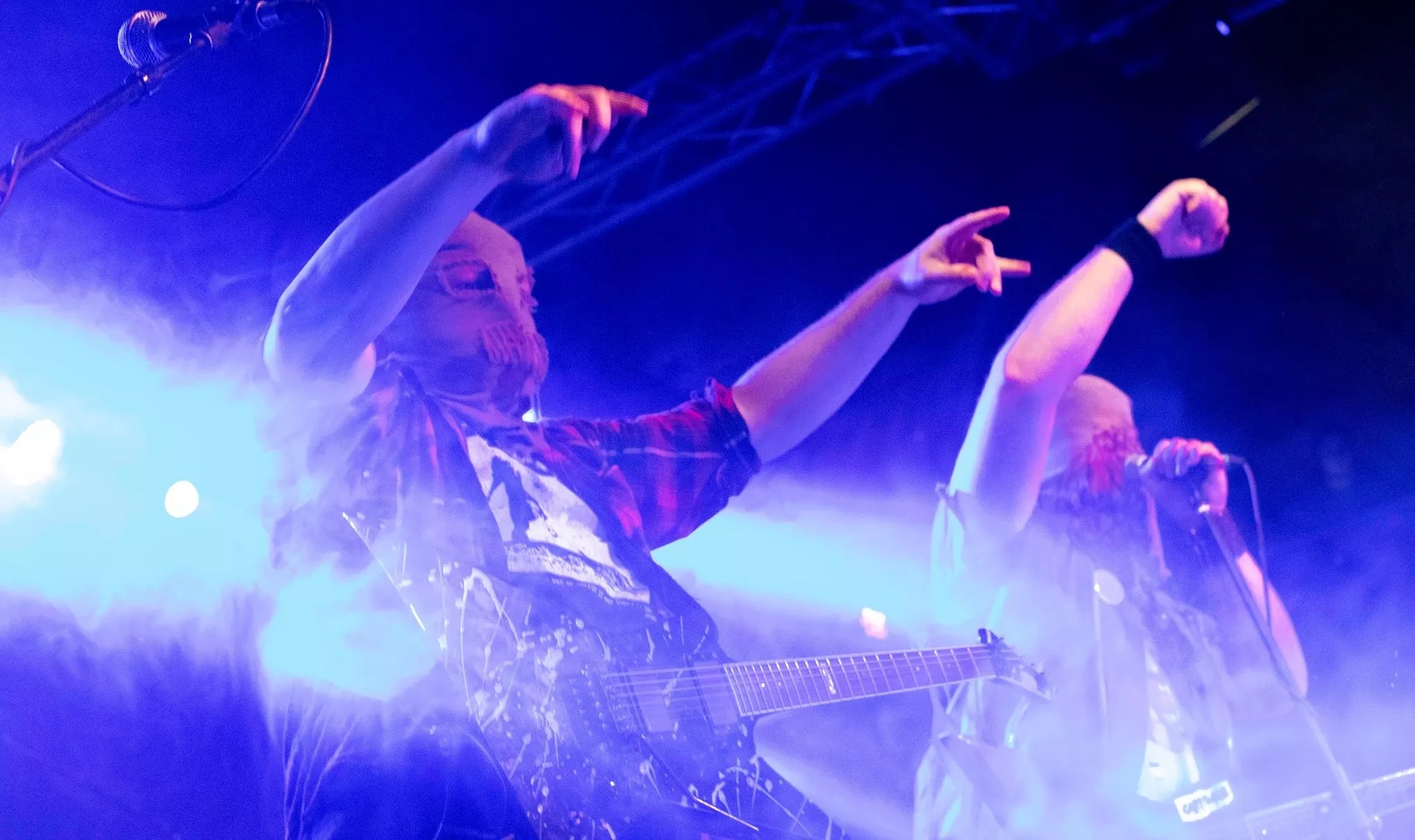man with burlap sack over his head pointing