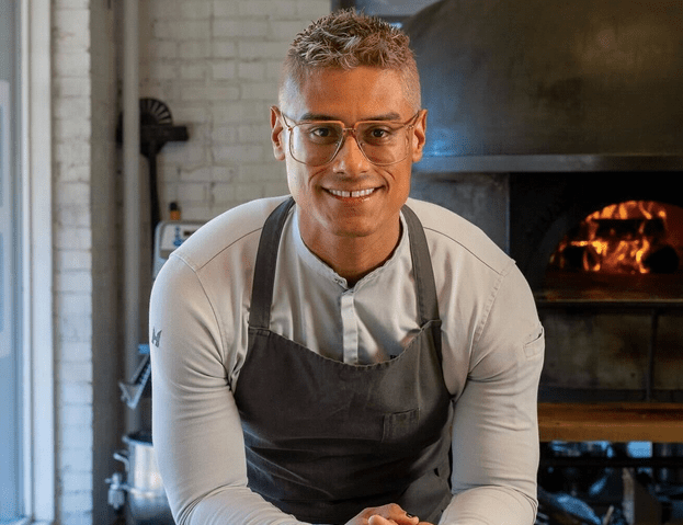 a man in glasses wearing an apron