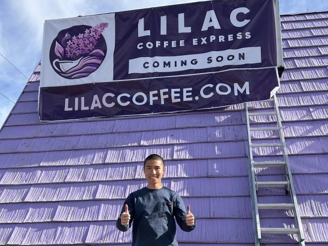 a man standing in front of a purple building