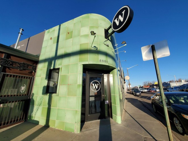 front door of a building with green tile