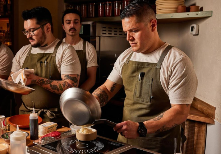 chefs cooking in a small kitchen