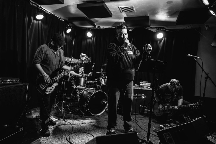 band performing in a DIY venue