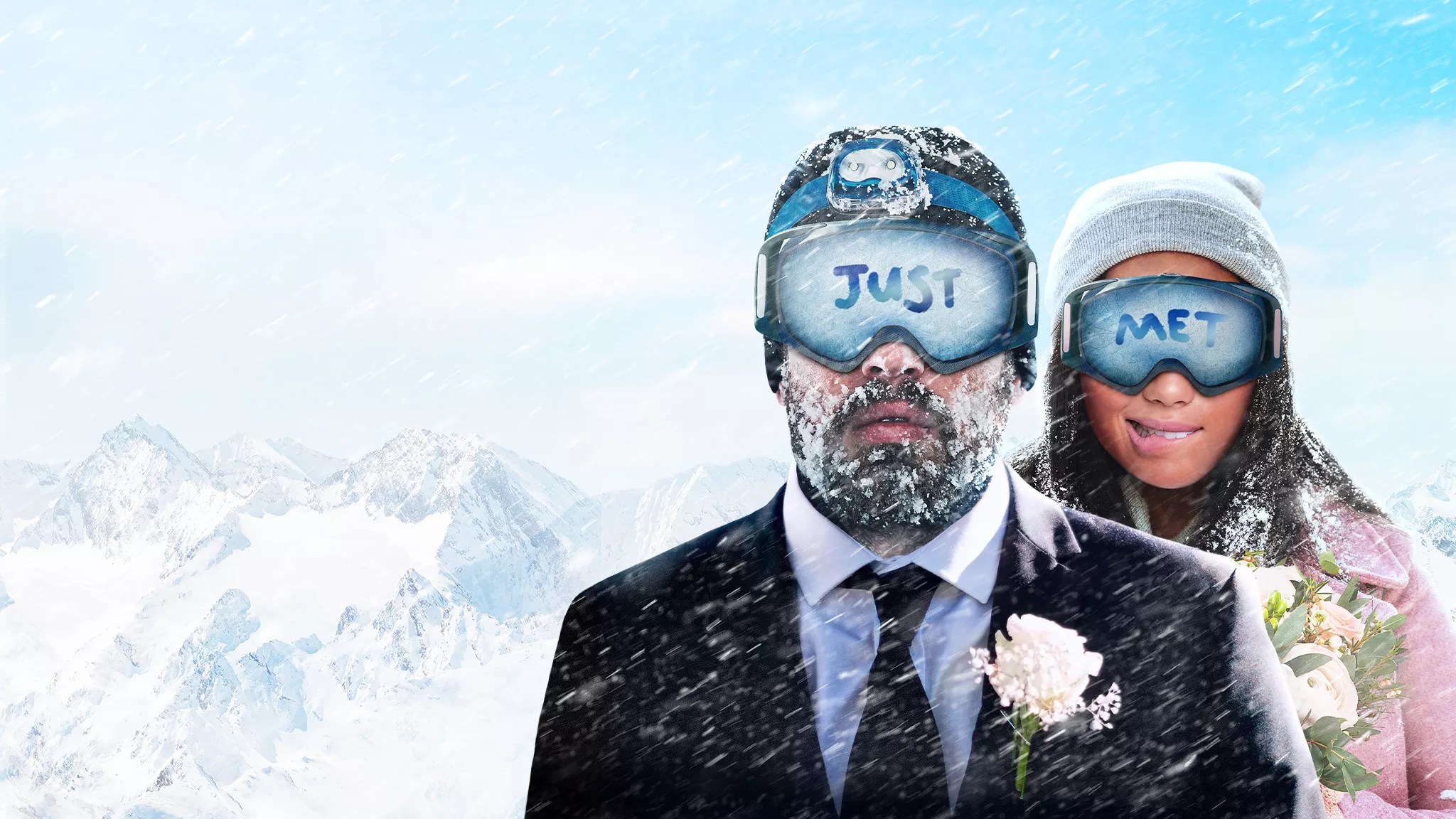 bride and groom in snow and goggles.
