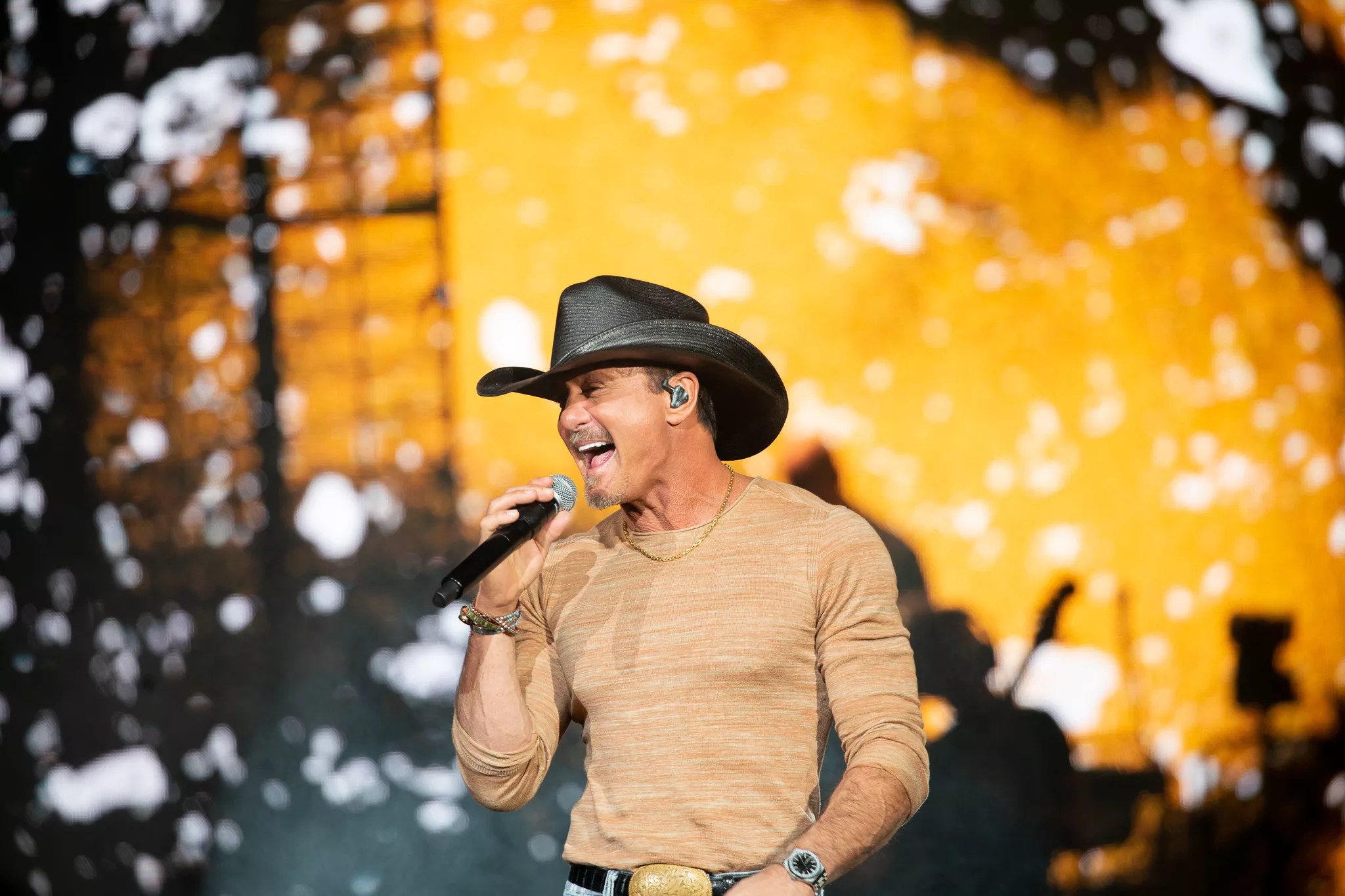 man in cowboy hat singing