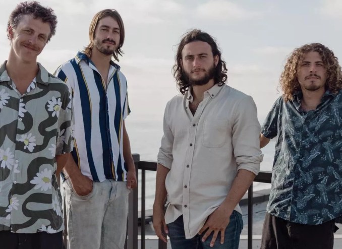 four men in buttondown shirts posing for a photo