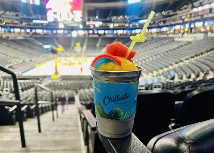 a frozen drink in a cup inside an arena