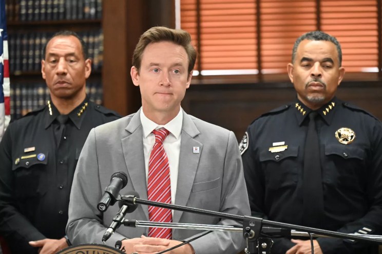 Denver Mayor Mike Johnston speaks to the press.