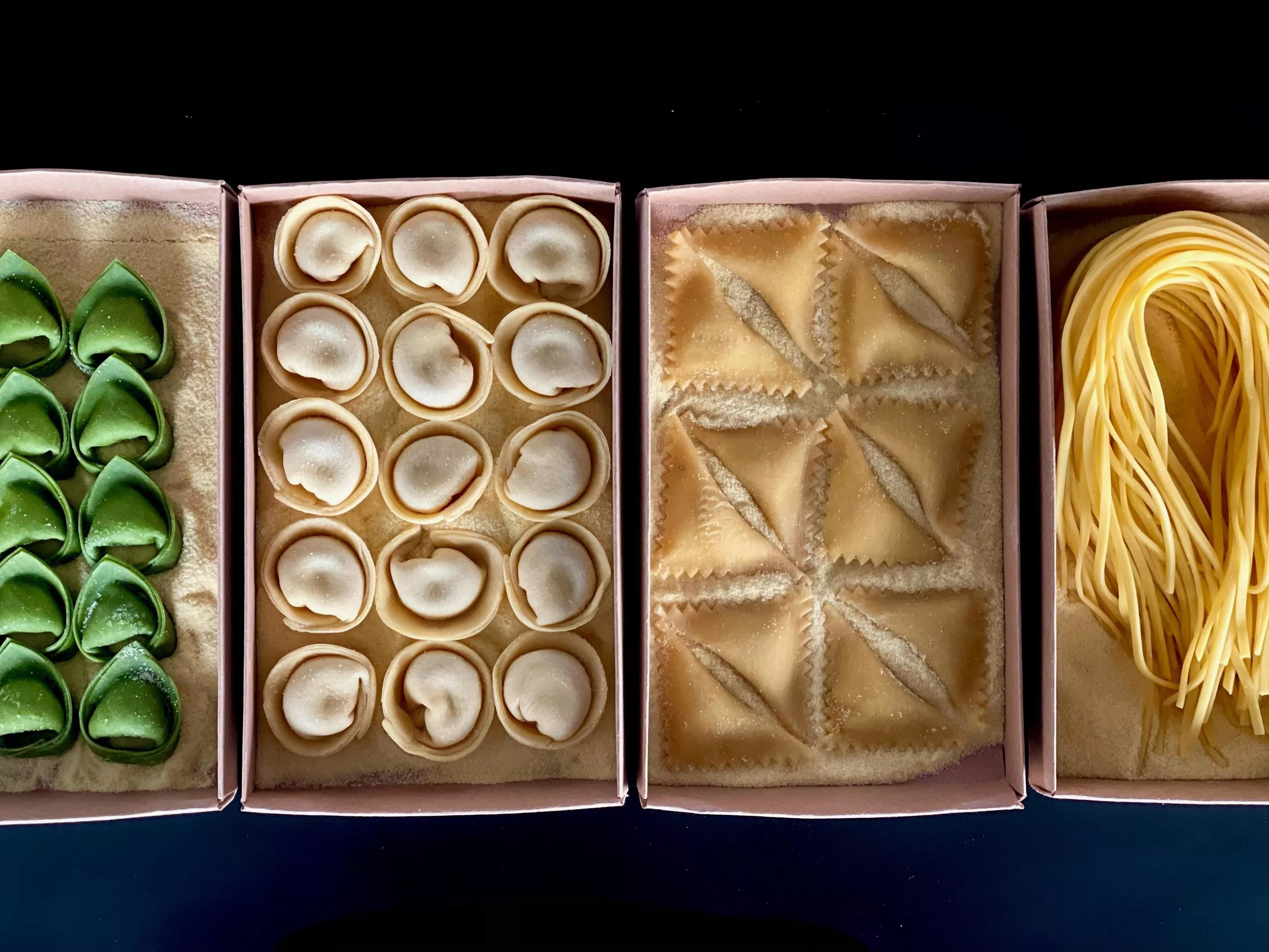 various pasta shapes on trays