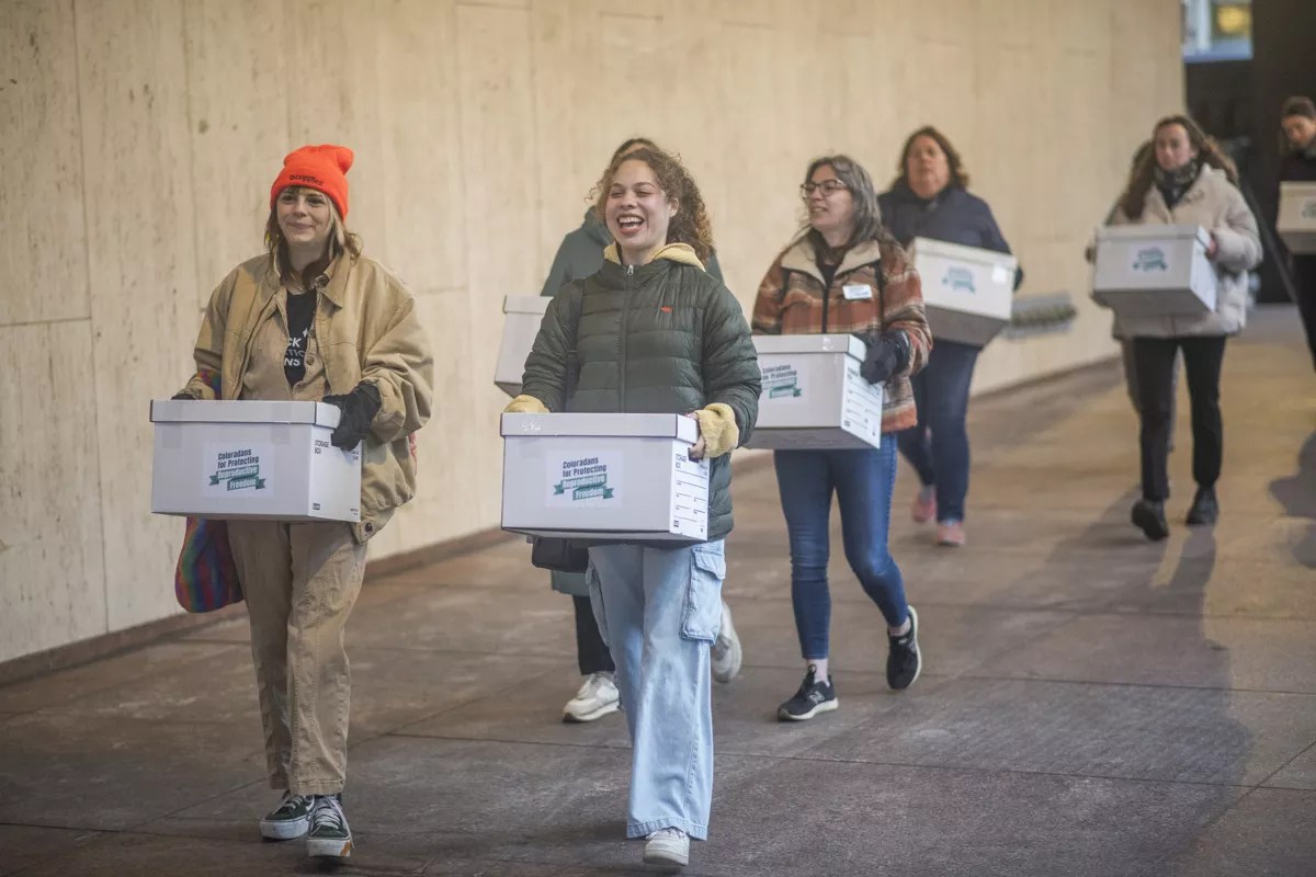 Members of Coloradans for Protecting Reproductive Freedom turn in 99 boxes of petition signatures in support of an abortion rights ballot measure proposal on April 18, 2024.