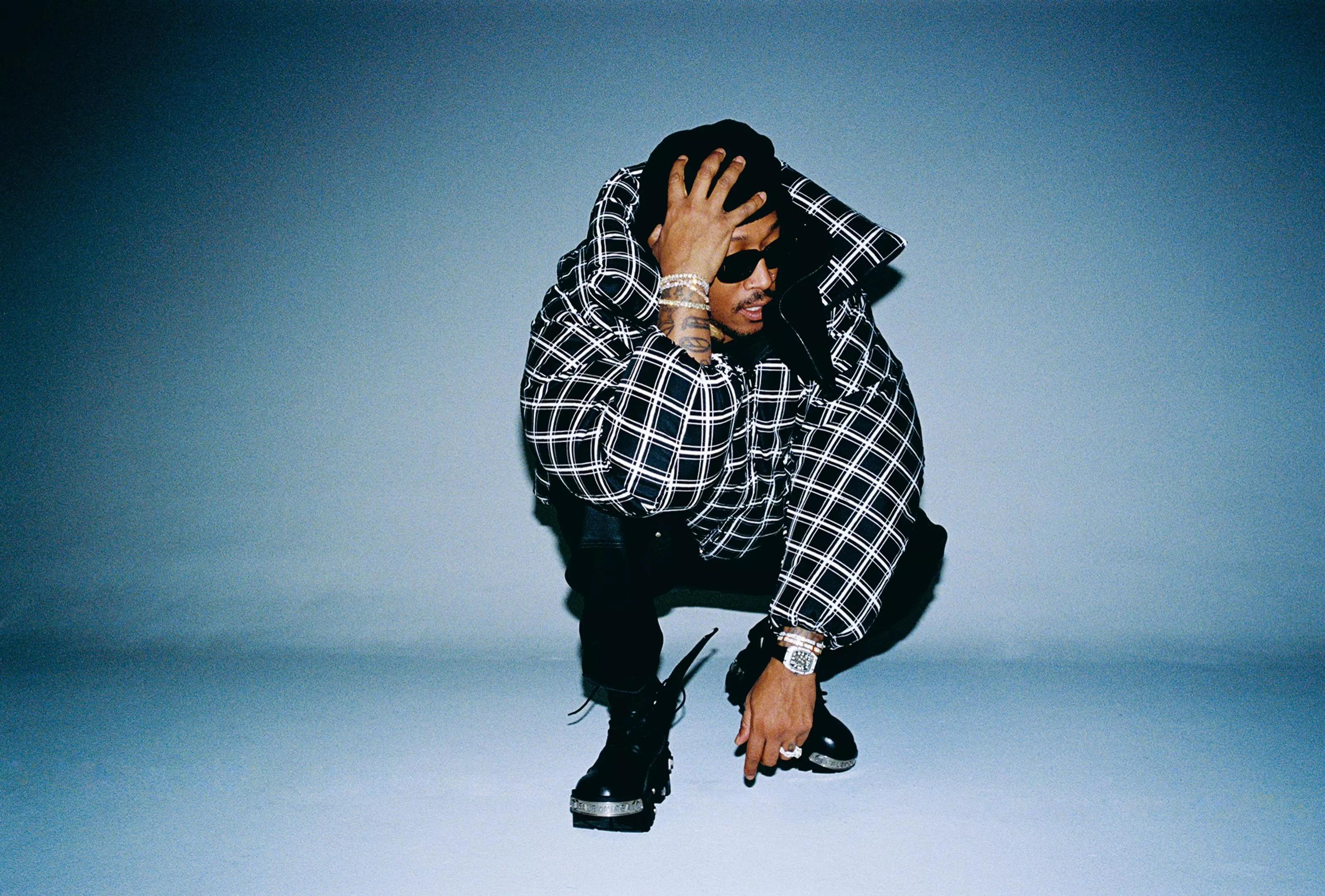 man crouched holding his head