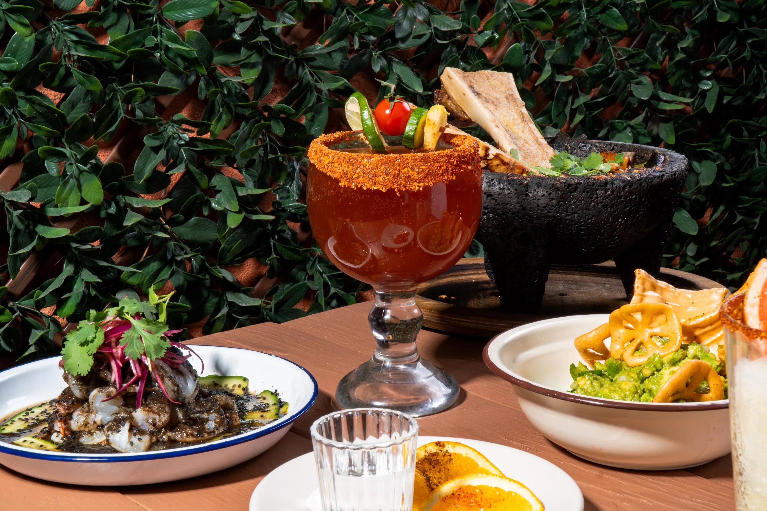 Michelada and various dishes on a table