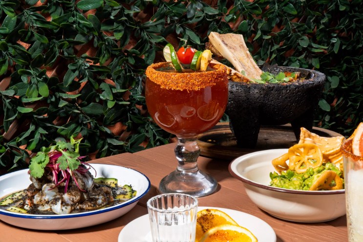 Michelada and various dishes on a table