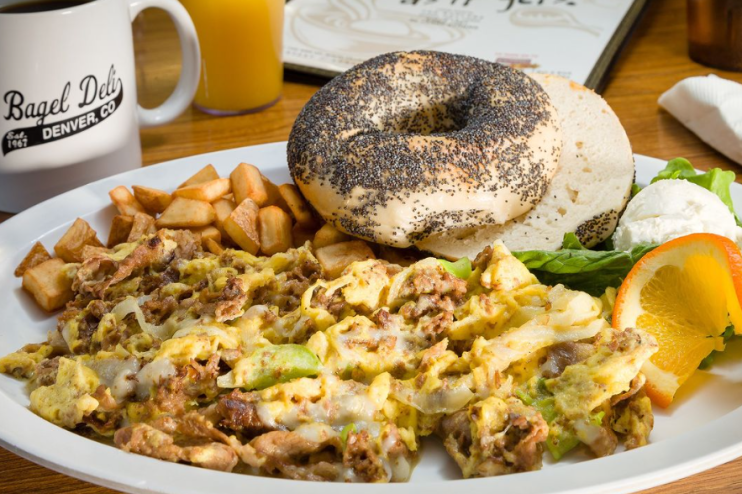 veggies mixed into eggs, fried potatoes and bagel