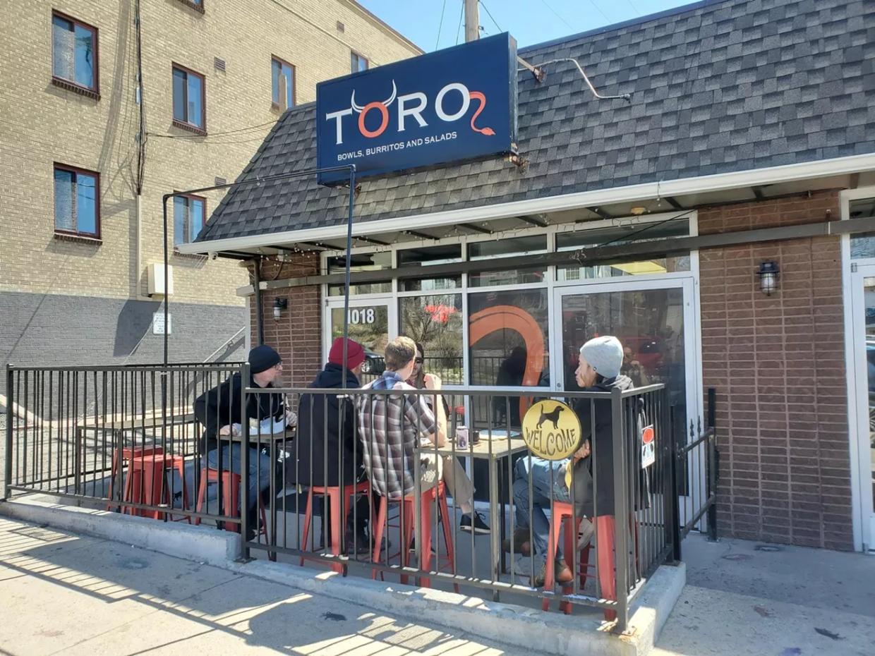 people eating outside on restaurant patio.