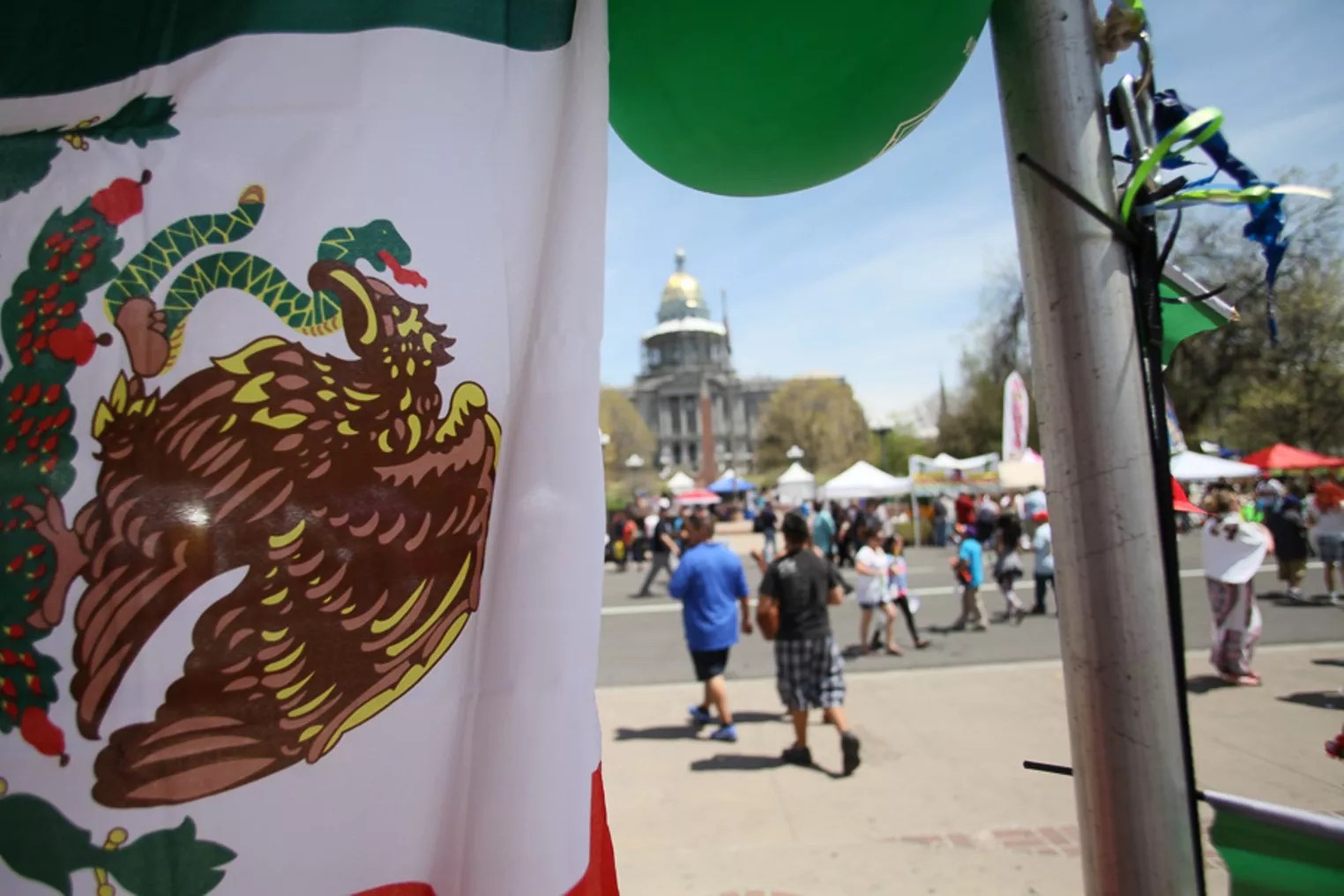 Mexican flag, green balloon at event.