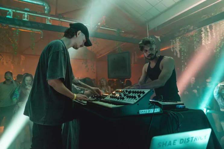 two djs performing