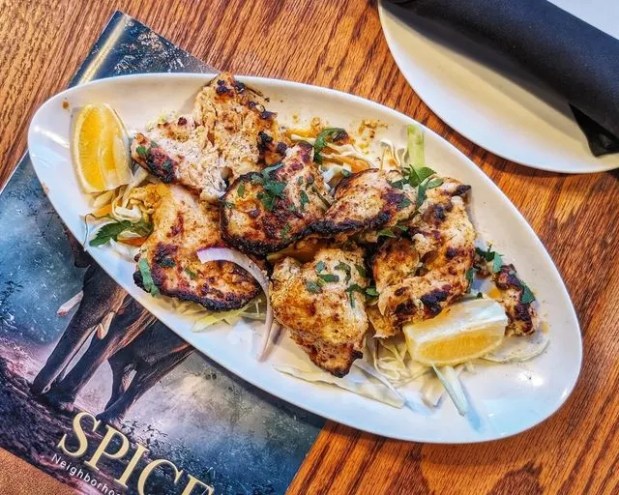 chicken kabobs on a white oval plate