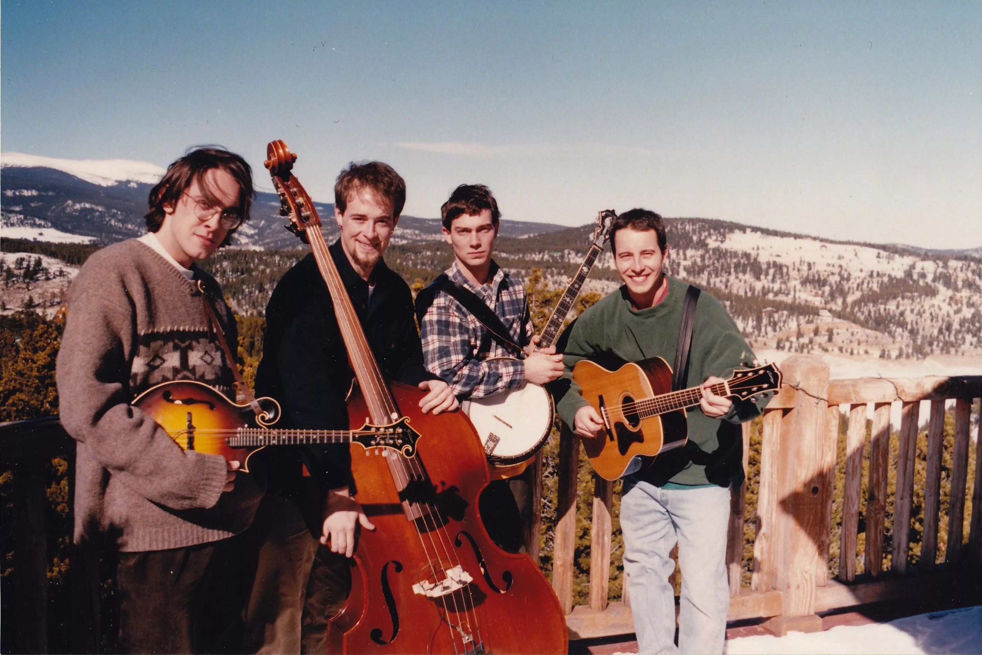bluegrass band poses with mountain backdrop