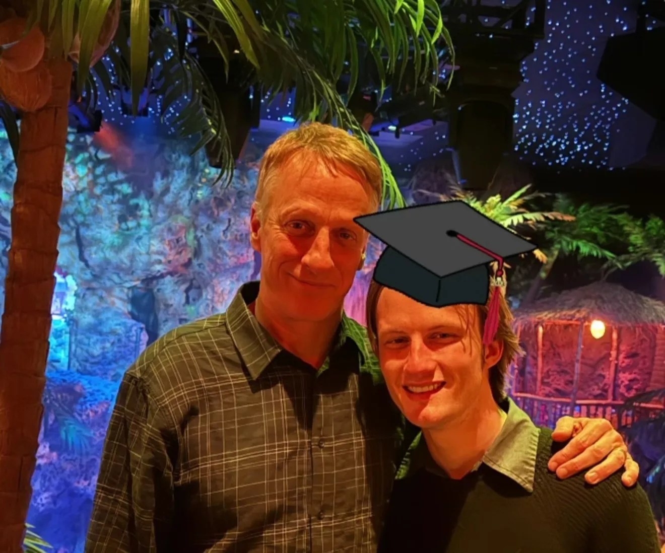 Man and son in graduation hat at Casa Bonita.
