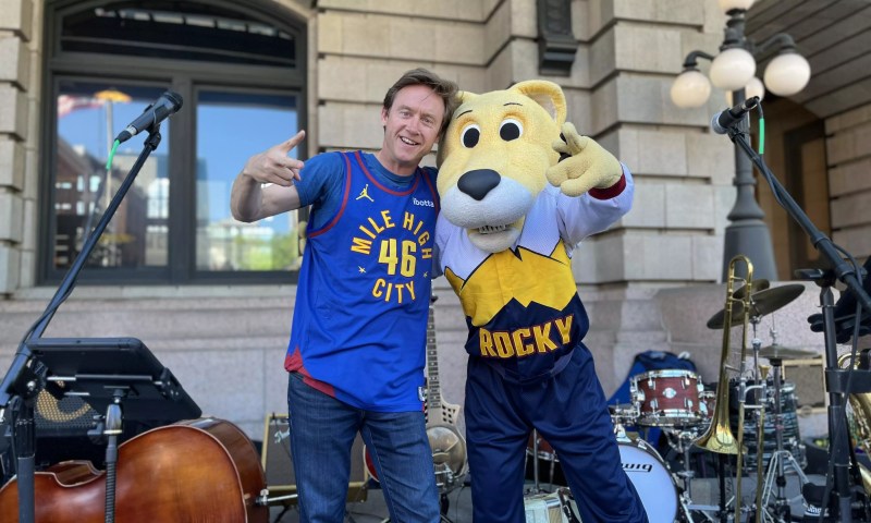 Denver mayor in nuggets gear with mountain lion mascot