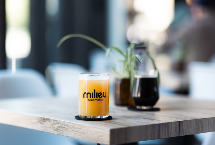 Glass of hazy IPA beer on a table.