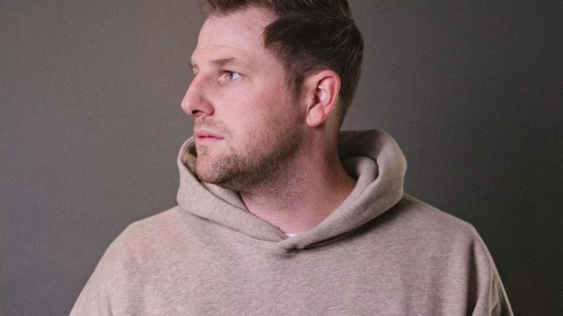 man in a tan sweatshirt