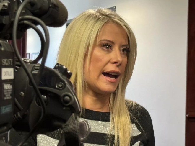 A woman talks to the media.