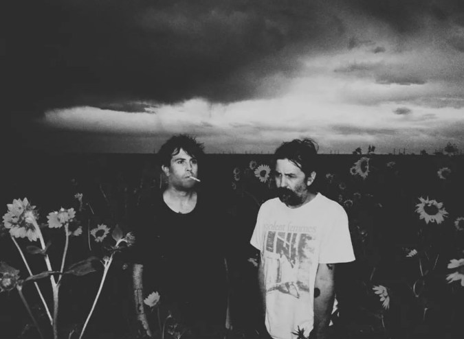 two men standing in a field