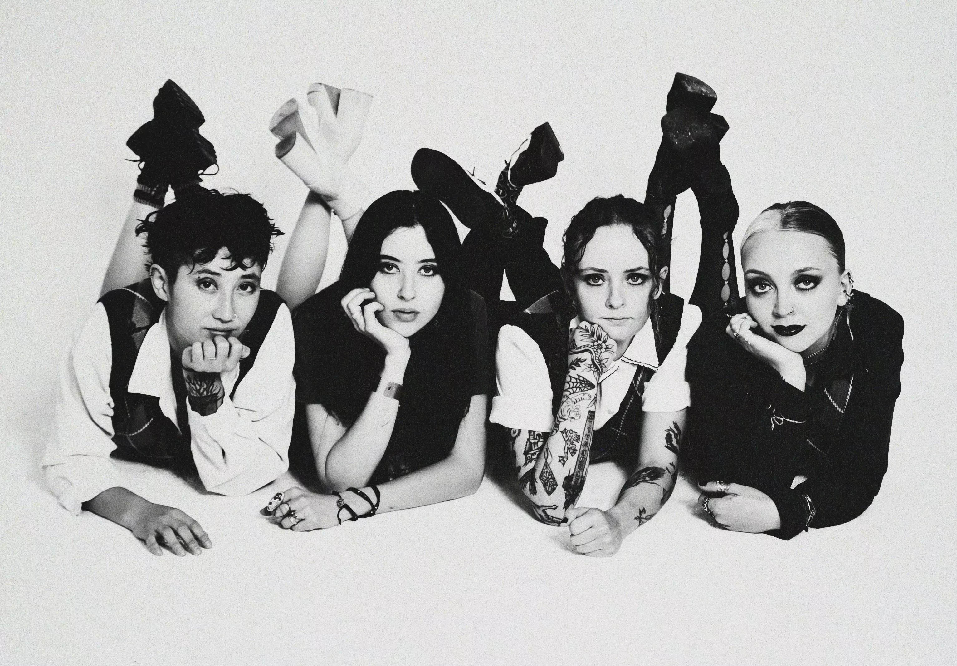 four women posing on the ground